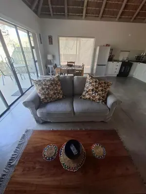 a living room with a couch and a table at Amukela Kaya in Hoedspruit