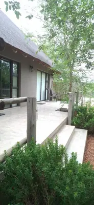 a porch of a house with a wooden fence at Amukela Kaya in Hoedspruit