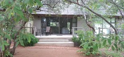 a porch of a house with a table and chairs at Amukela Kaya in Hoedspruit
