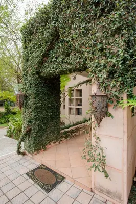a building with ivy growing on the side of it at 4 Gazelle Guesthouse in Nelspruit