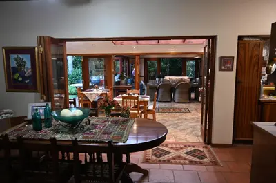a kitchen and dining room with a table and chairs at LUXURY EN-SUITE ROOM WITH LOUNGE @ 4 STAR GUEST HOUSE in Middelburg