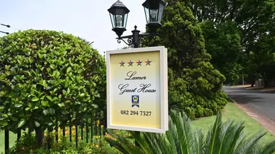 a sign on a light pole next to a street at LUXURY EN-SUITE ROOM WITH LOUNGE @ 4 STAR GUEST HOUSE in Middelburg