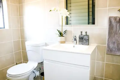 a bathroom with a toilet and a sink at Twelve Eighty at The Blyde Crystal Lagoon in Pretoria