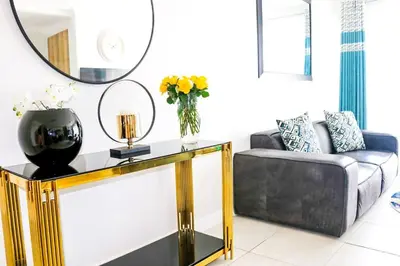 a living room with a couch and a mirror at Twelve Eighty at The Blyde Crystal Lagoon in Pretoria