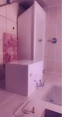 a white bathroom with a sink and a mirror at RnR Crystal Lagoon in Pretoria