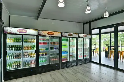 a large refrigerator filled with lots of drinks at SleepOver Orpen Gate in Acornhoek