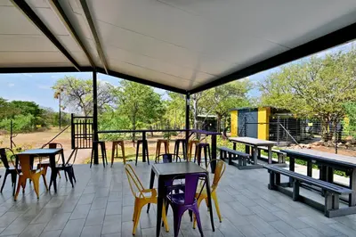 a group of tables and chairs on a patio at SleepOver Beitbridge in Musina