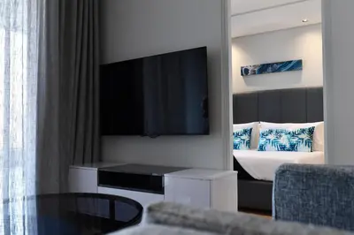 a hotel room with a bed and a television at Ellipse Waterfall Executive Apartments in Midrand