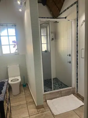 a bathroom with a shower and a toilet at Goldpot Faerie Glen near Sun Bet Arena in Pretoria