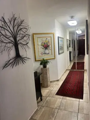 a hallway with a painting of a tree on the wall at Goldpot Faerie Glen near Sun Bet Arena in Pretoria