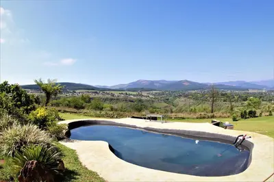 a swimming pool with a view of the mountains at Waterval Self-Catering Holiday Home in Sabie