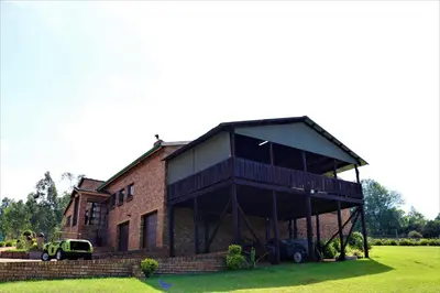 a large brick building with a balcony on top of it at Waterval Self-Catering Holiday Home in Sabie