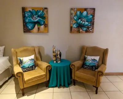 two chairs and a table in a room at Waterval Self-Catering Holiday Home in Sabie