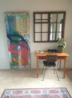 a table with a chair next to a stained glass window at Bronberg Bastion in Tierpoort