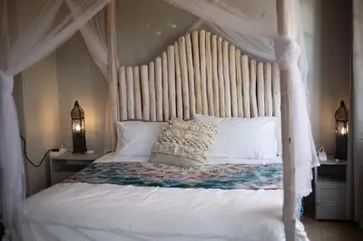 a bedroom with a white bed with a canopy at Bronberg Bastion in Tierpoort