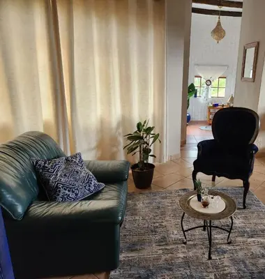 a living room with a couch and a table at Bronberg Bastion in Tierpoort