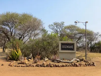 a sign in the middle of a dirt road at Isilwane Bush Camp in Pretoria