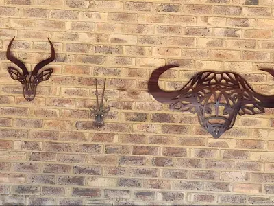 two animal heads on a brick wall at Isilwane Bush Camp in Pretoria