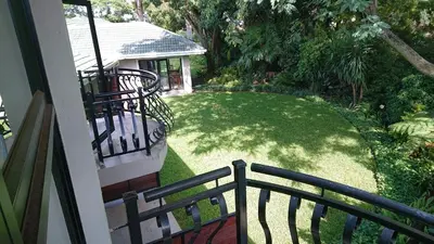 a balcony of a house with a yard of grass at Unitas Guesthouse in Centurion