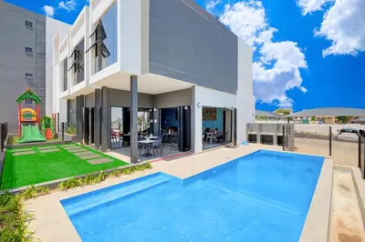 a house with a swimming pool in front of it at Smart Apartment in Midrand
