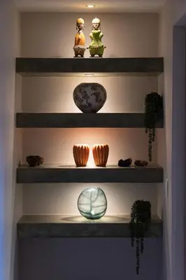 a set of shelves with bowls and vases on them at Kruger River Lodge in Hoedspruit