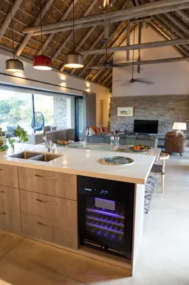 a kitchen with a large island with a stove top oven at Kruger River Lodge in Hoedspruit