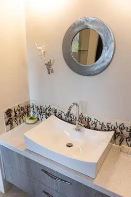 a bathroom with a sink and a mirror at Kruger River Lodge in Hoedspruit
