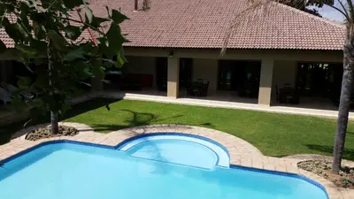 a swimming pool in the yard of a house at Summerset Place Country House in Bela-Bela