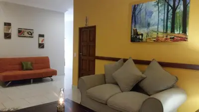 a living room with a couch and a chair at Summerset Place Country House in Bela-Bela