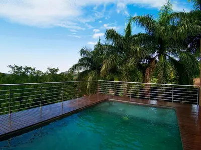 a swimming pool on the balcony of a house at Schimper View Boutique Guest House in Louis Trichardt