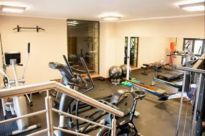 a gym with several treadmills and cardio machines at Schimper View Boutique Guest House in Louis Trichardt