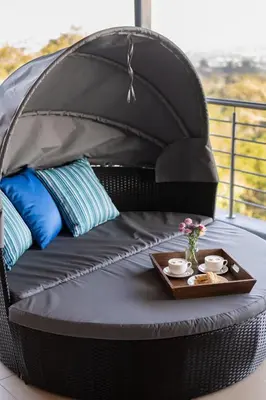 a black wicker dog bed with a tray of food at Schimper View Boutique Guest House in Louis Trichardt