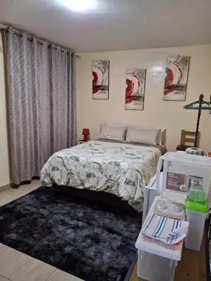a bedroom with a bed and a rug in it at Cosy Beds Web in Witbank