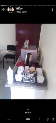 a kitchen counter with dishes and a toaster at Cosy Beds Web in Witbank