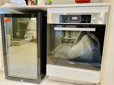 a microwave oven with its door open in a kitchen at Menlyn Maine Trilogy Hotel in Pretoria