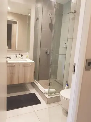 a bathroom with a shower and a sink and a toilet at Menlyn Maine Trilogy Hotel in Pretoria