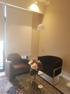 a living room with a couch and a glass table at Menlyn Maine Trilogy Hotel in Pretoria