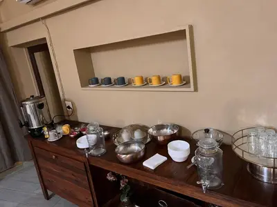 a wooden counter with bowls and dishes on a shelf at Musina Hotel in Musina