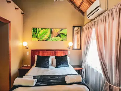 a bedroom with a bed and a window at Musina Hotel in Musina