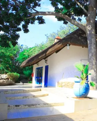a house with a blue vase in front of it at Sandriver Resort in Musina