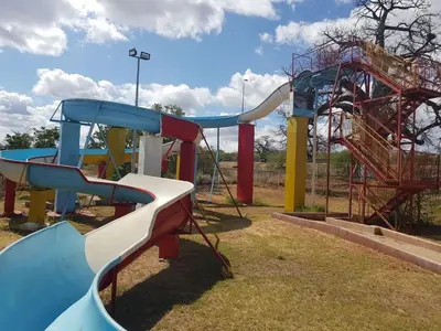 a playground with a slide in a park at Sandriver Resort in Musina