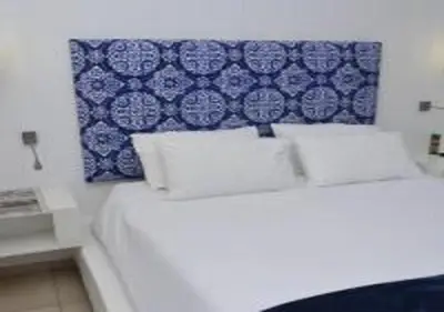 a bedroom with a bed with a blue and white wall at Sandriver Resort in Musina