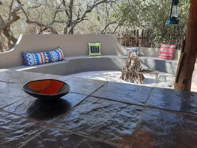 a stone table with a fountain in a yard at African Bush Escape in Marloth Park