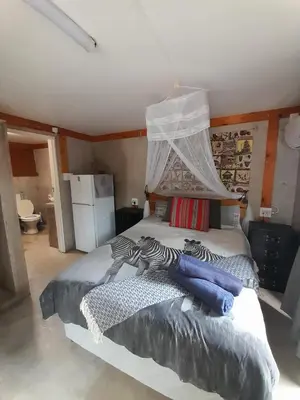a bedroom with a large bed with a canopy at African Bush Escape in Marloth Park