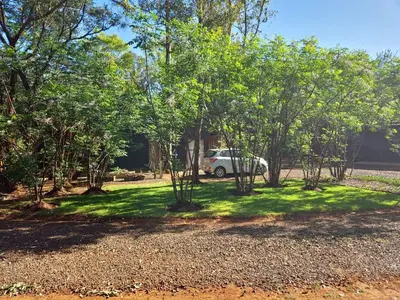 a car parked in a yard with trees at Vulture's View 1 in Hartbeespoort
