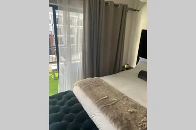 a bedroom with a bed and a large window at The Blyde Silverlakes in Boschkop