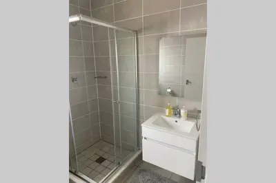 a bathroom with a shower and a sink and a mirror at The Blyde Silverlakes in Boschkop