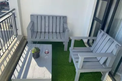 a balcony with two benches and a potted plant at The Blyde Silverlakes in Boschkop