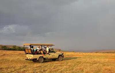 a group of people in a jeep in a field at Lindani Game and Lodges in Vaalwater