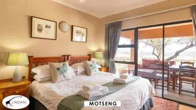 a bedroom with a bed with towels on it at Lindani Game and Lodges in Vaalwater